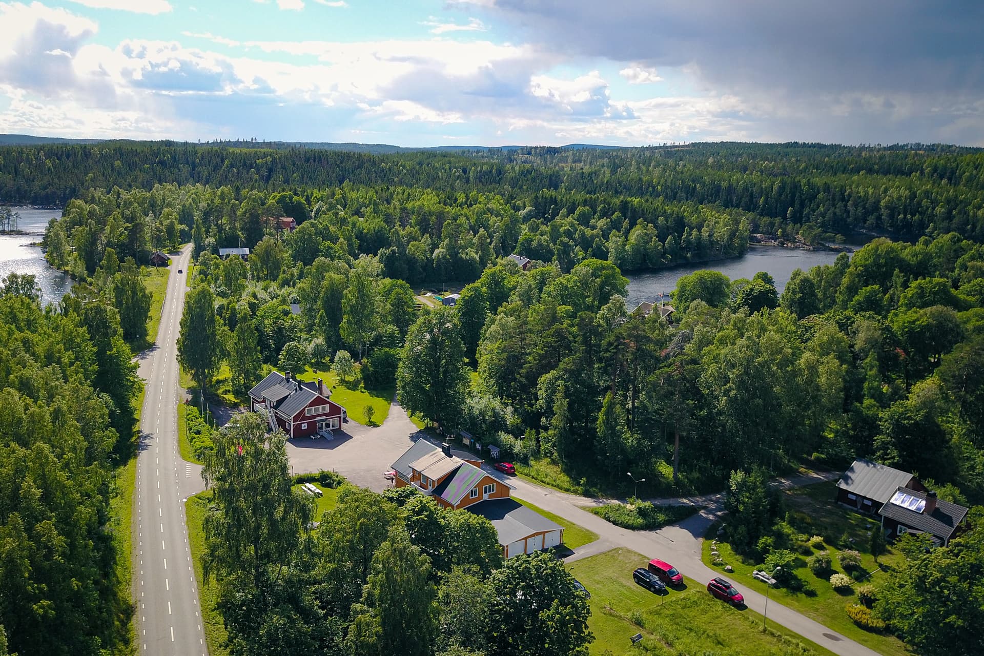 Bird's eye view of the canoe center, wilderness lodge, and wilderness cottage surrounded by lakes and lush green wilderness.