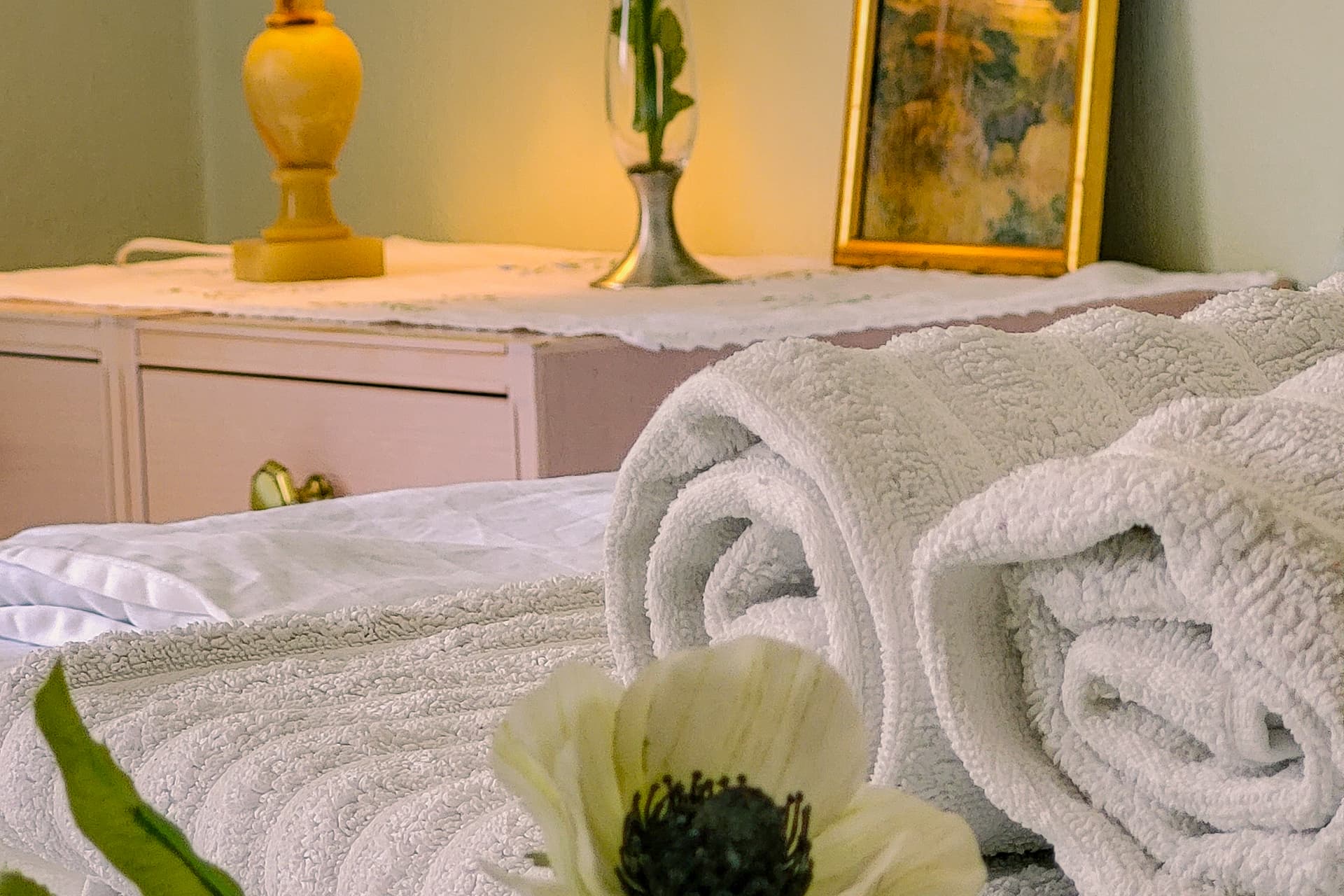 Close-up of towels, bed, and flowers at the wilderness lodge.