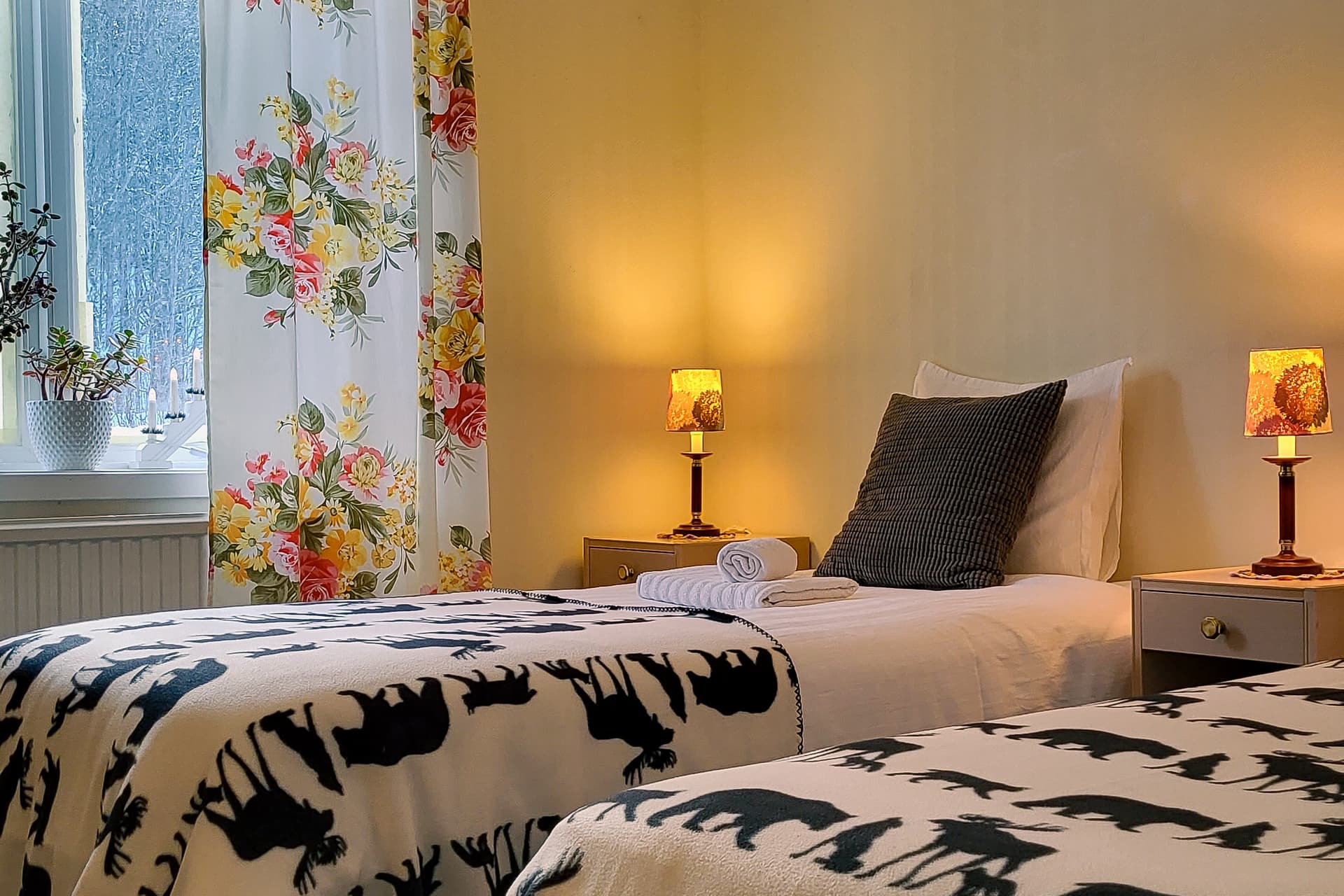 Freshly made beds in the Bear Room at Wilderness Lodge in Sweden.
