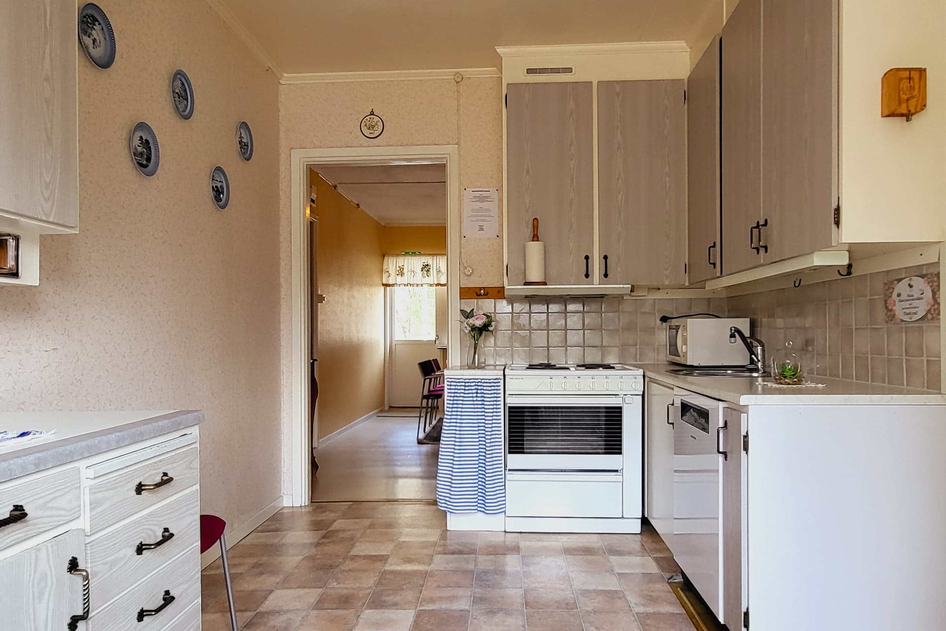 A cozy kitchen with a stove, sink, microwave, and fridge available for guests at the wilderness lodge.