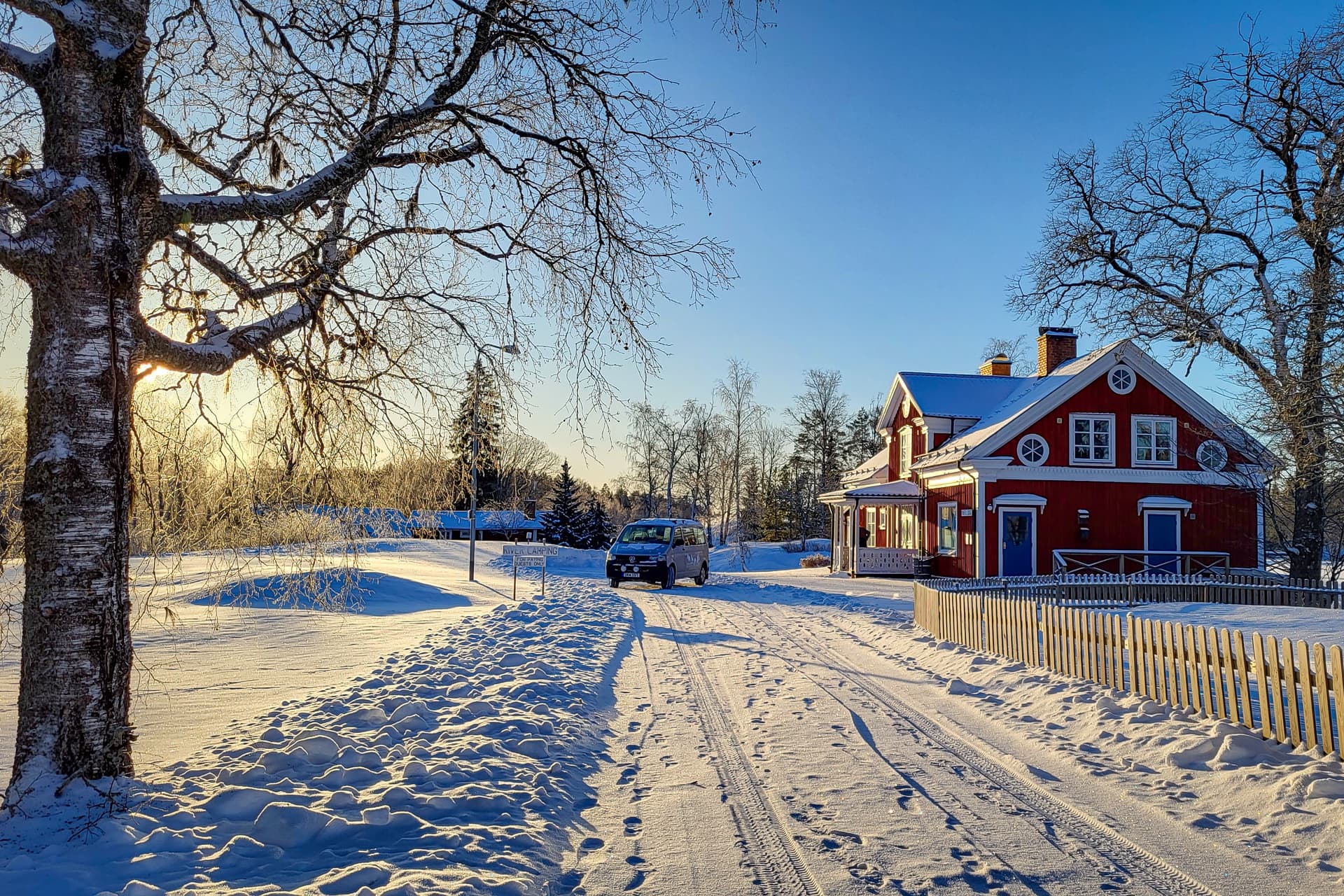 A snow-covered road leading to the River Lodge in the middle of the Swedish winter.